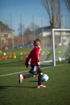 Boy practicing soccer Stock Photos