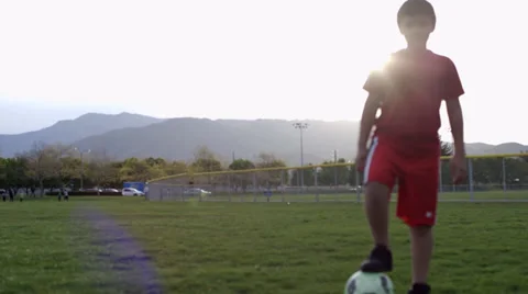 Boy practicing soccer trick Video stock 37408176