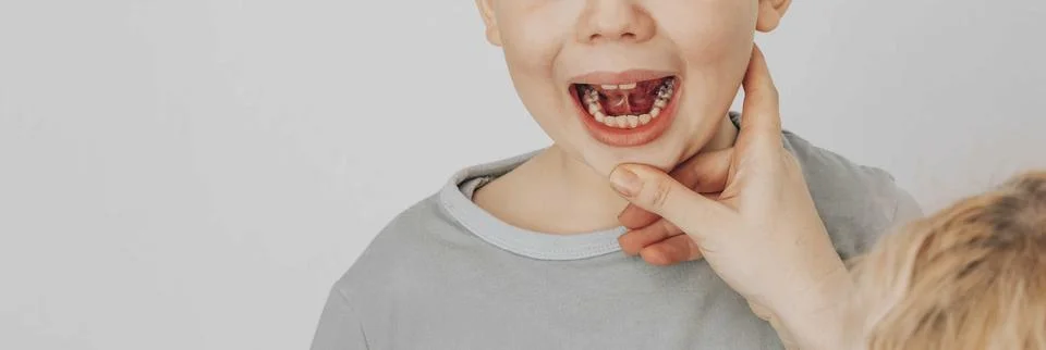 Boy practicing speech therapy exercises while looking at in bright educational Stock Photos
