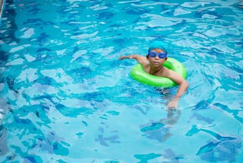 Boy practicing swimming in the pool Stock Photos