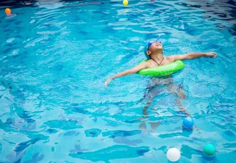 Boy practicing swimming in the pool Stock Photos