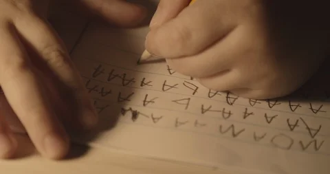 Boy practising handwriting with pencil. Stock Footage 127603032