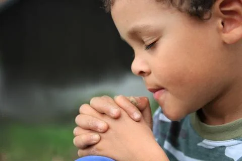 Boy praying to God stock photo Stock Photos