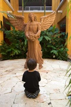 Boy praying on his knees Stock Photos