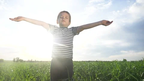 Boy prays pulls hands to the sky against a blue sky. child concept faith Stock Footage 132961769
