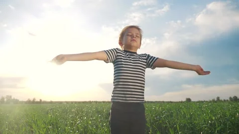 Boy prays pulls hands to the sky against a blue sky. child concept faith Stock Footage 166416789