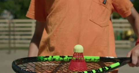 Boy prepares for a game of badminton Stock Footage 344900576