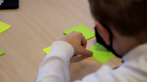 The boy prepares to write the test on a piece of paper during the test. Stock Footage 152008141