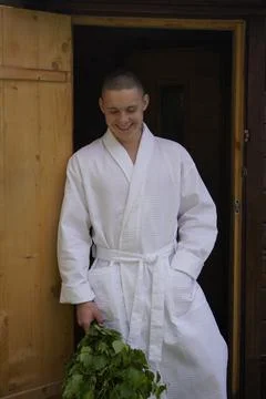Boy is preparing for bath procedures, made a birch broom and poses on the Stock Photos