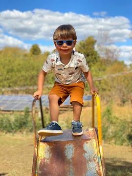 Boy preparing to go down the slide. Stock Photos
