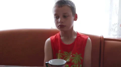 Boy preparing to receive food, dinner, sitting at the table Stock Footage 64979543