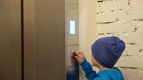 A boy presses the elevator call button Stock Footage 247790501