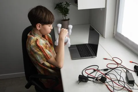 Boy programming robot learning stem skills at home desk Stock Photos
