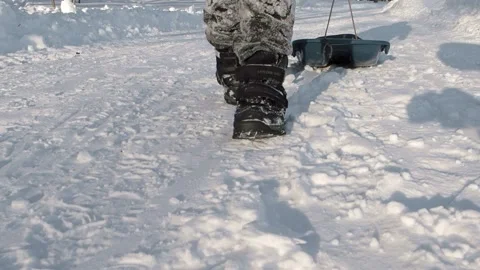 Boy pulling a sled Stock Footage 237478878
