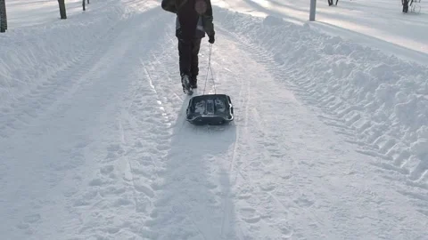 Boy pulling a sled Stock Footage 237478911