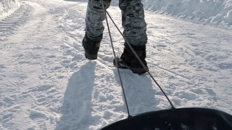 Boy pulling a sled Stock Footage 237478967