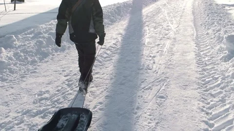 Boy pulling a sled Stock Footage 237479001