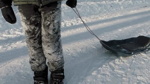 Boy pulling a sled Stock Footage 237479005
