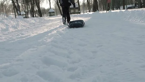 Boy pulling a sled Stock Footage 237479033