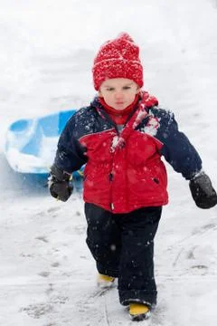 Boy pulling sled Stock Photos