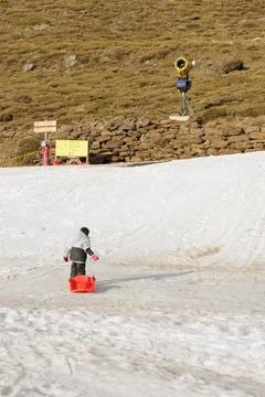 Boy pulling a sled Stock Photos