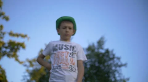 Boy pulls out a gun and shoots at the camera, gangster, slow motion Video stock 65323716