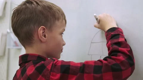 Boy pupil draws on the chalkboard while studying at school. Stock Footage 162613036