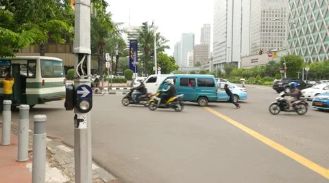 Boy push stalled minivan, crowded traffic area street junction, side view Video stock 51715314