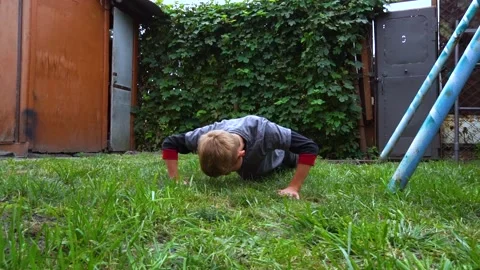 The boy pushes up from the floor Stock Footage 207770095