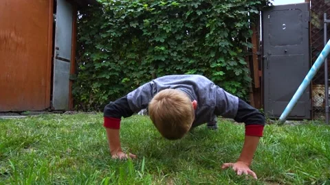 The boy pushes up from the floor Stock Footage 207771434