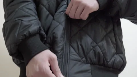 The boy put on a black jacket Stock Footage 250757588