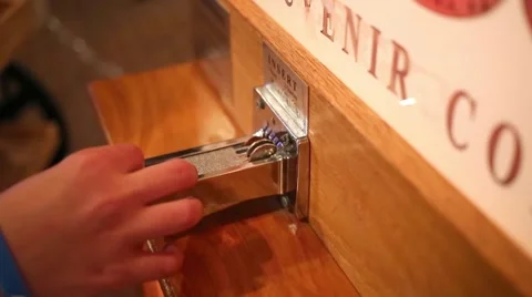 Boy put coin and turn the lever of coin pressing souvenir machine Video stock 61769161