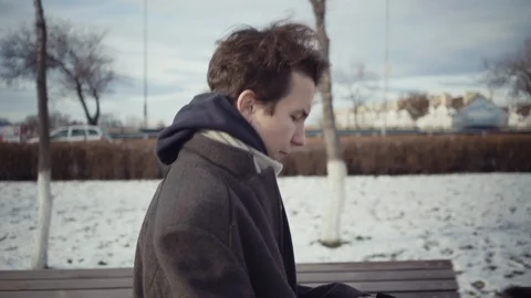 Boy put on a hat at winter Stock Footage 119334546