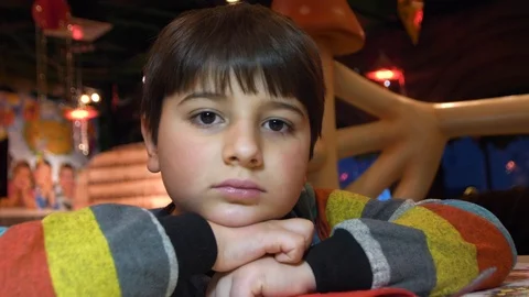The boy put his head in his hands and smiles Stock Footage 86081426