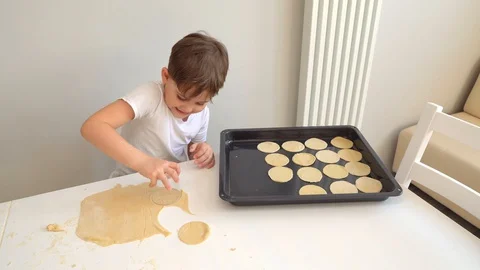 A boy puts the dough in the shape of a Cup on a baking sheet Video stock 128828171