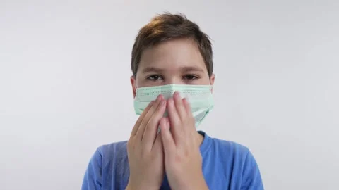 Boy puts on face mask Stock Footage 241016131