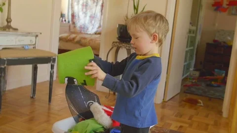 Boy puts felt bucket on his head Stock Footage 76547112