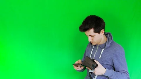 Boy puts mobile and set the 3D VR glasses with green screen Stock Footage 61250761