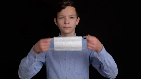 Boy puts up protective mask from viruses Stock Footage 124366747