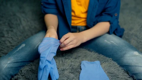 The boy puts on rubber gloves. Environmental and health concept. Stock Footage 127568444