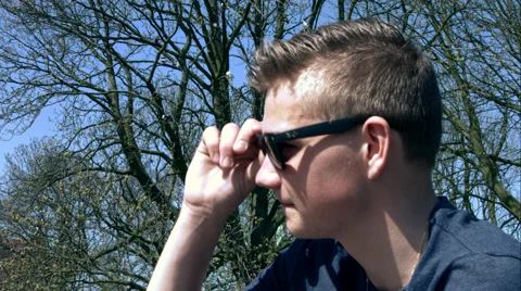 Boy puts sunglasses on Stock Footage 49164250