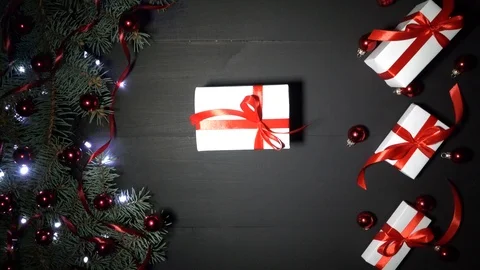 A boy puts a xmas gift on the table, then takes it back Stock Footage 99063600