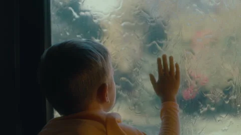 Boy putting his hand on the window Stock Footage 279073035