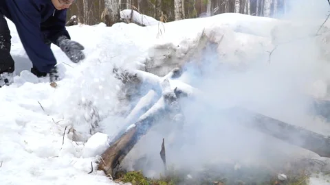 A boy is putting out the fire with snow. Stock-Footage 88638761