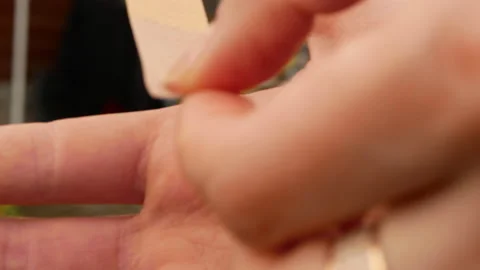 Boy putting plaster on his palm Stock Footage 154296525