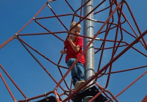 Boy on pyramid net climber Stock Photos