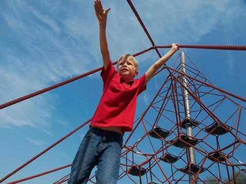 Boy on pyramid net climber Stock Photos
