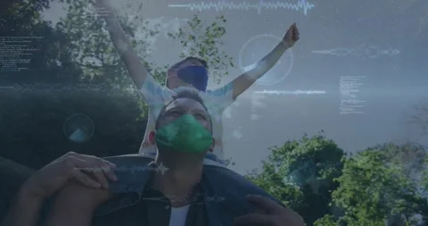 Boy raising arms initiating data visuals swirling around father holding legs in Stock Footage 320506712
