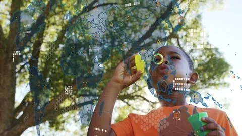 Boy raising wand to lips, blowing bubbles to play while tech HUD staying Stock Footage 333485577