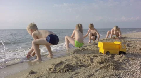 The boy ran away from sea waves. Young children having fun. Stock-Footage 65437430